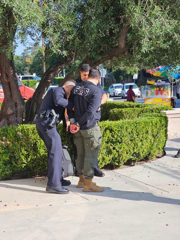 A man is taken into police custody outside an event where Democratic presidential candidate Robert F. Kennedy Jr. was scheduled to speak at Wilshire Ebell Theatre in Los Angeles on Sept. 15, 2023. (Provided to The Epoch Times)