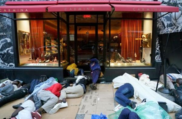 Illegal immigrants sleep outside the Roosevelt Hotel while waiting for placement at the hotel in New York on Aug. 1, 2023. (Timothy A. Clary/AFP via Getty Images)
