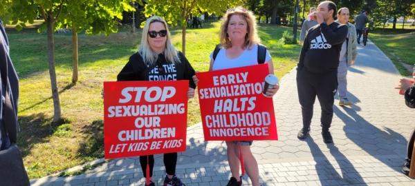 Protesters hold signs during a rally for parents' rights on Sept. 20, 2023, in Toronto. (Neil Sharma/The Epoch Times)