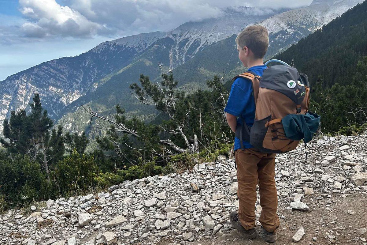 Frankie McMillan, 7, looks out across a mountain vista during a jaunt. (SWNS)