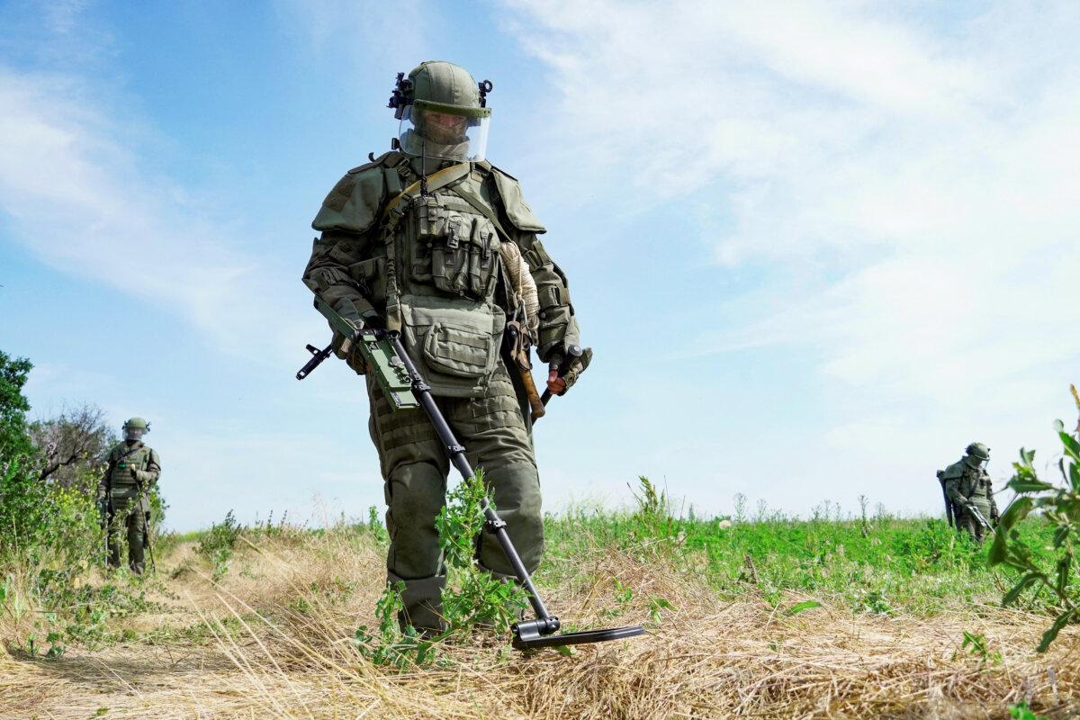 Russian servicemen wearing Explosive Ordnance Disposal (EOD) equipment while demining a field in the Donetsk, Ukraine, on June 23, 2023. (Stringer/AFP via Getty Images)