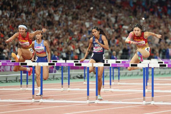LinYuwei (L) of China, Wu Yanni (R) of China, and Jyothi Yarraji of Team India compete in the Women's 100m Hurdles final athletics event on day 8 of the 19th Asian Games at Hangzhou Olympic Sports Center in Hangzhou, China, on Oct. 1, 2023. (Lintao Zhang/Getty Images)