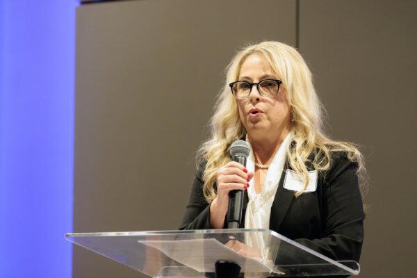 MaryJo Perry, president of the Mississippi Parents for Vaccine Rights, introduces Robert F. Kennedy Jr. at the Mississippi Civil Rights Museum in Jackson, Mississippi, on Oct. 2, 2023. (Courtesy of Charlotte Stringer Photography)