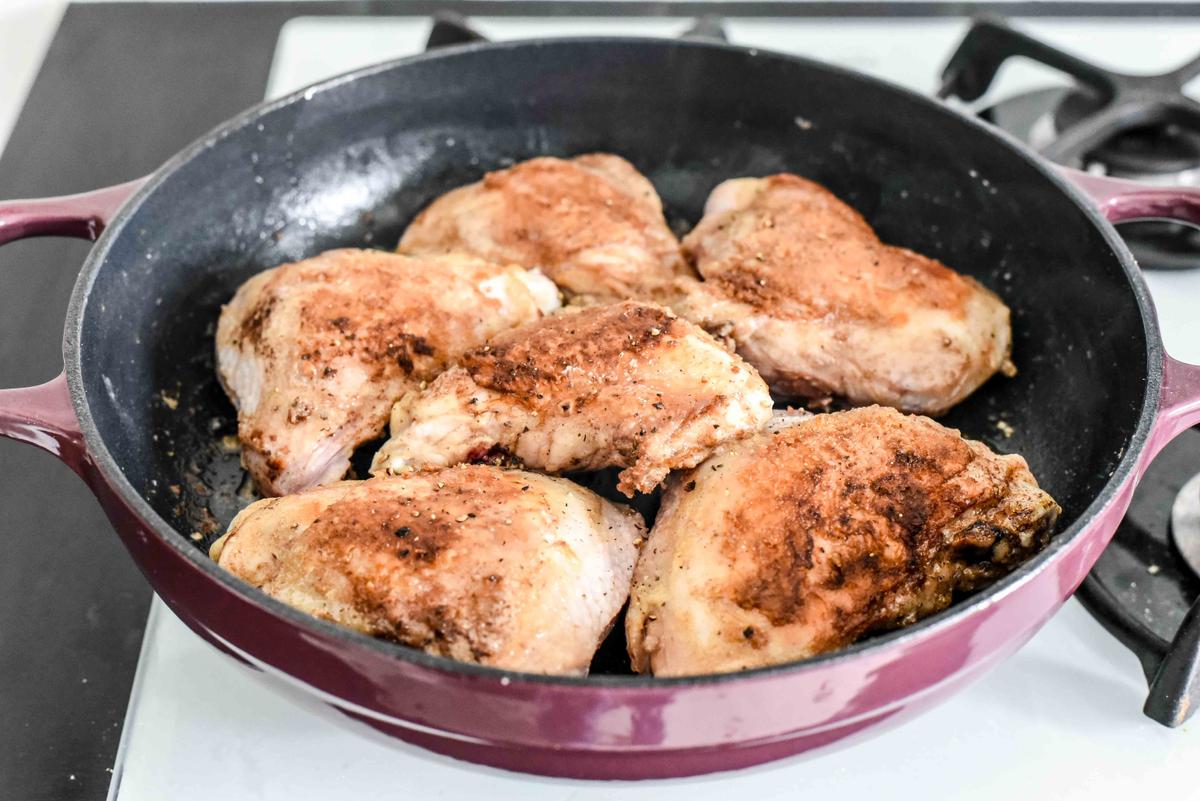 Searing the chicken thighs crisps up the skin and renders the fat into a flavorful base for the sauce. (Audrey Le Goff)