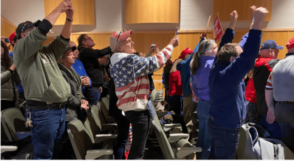 Trump supporters raise their cellphones to get a picture of the former president in Wolfeboro, N.H., on Oct. 9, 2023. (Alice Giordano/The Epoch Times)