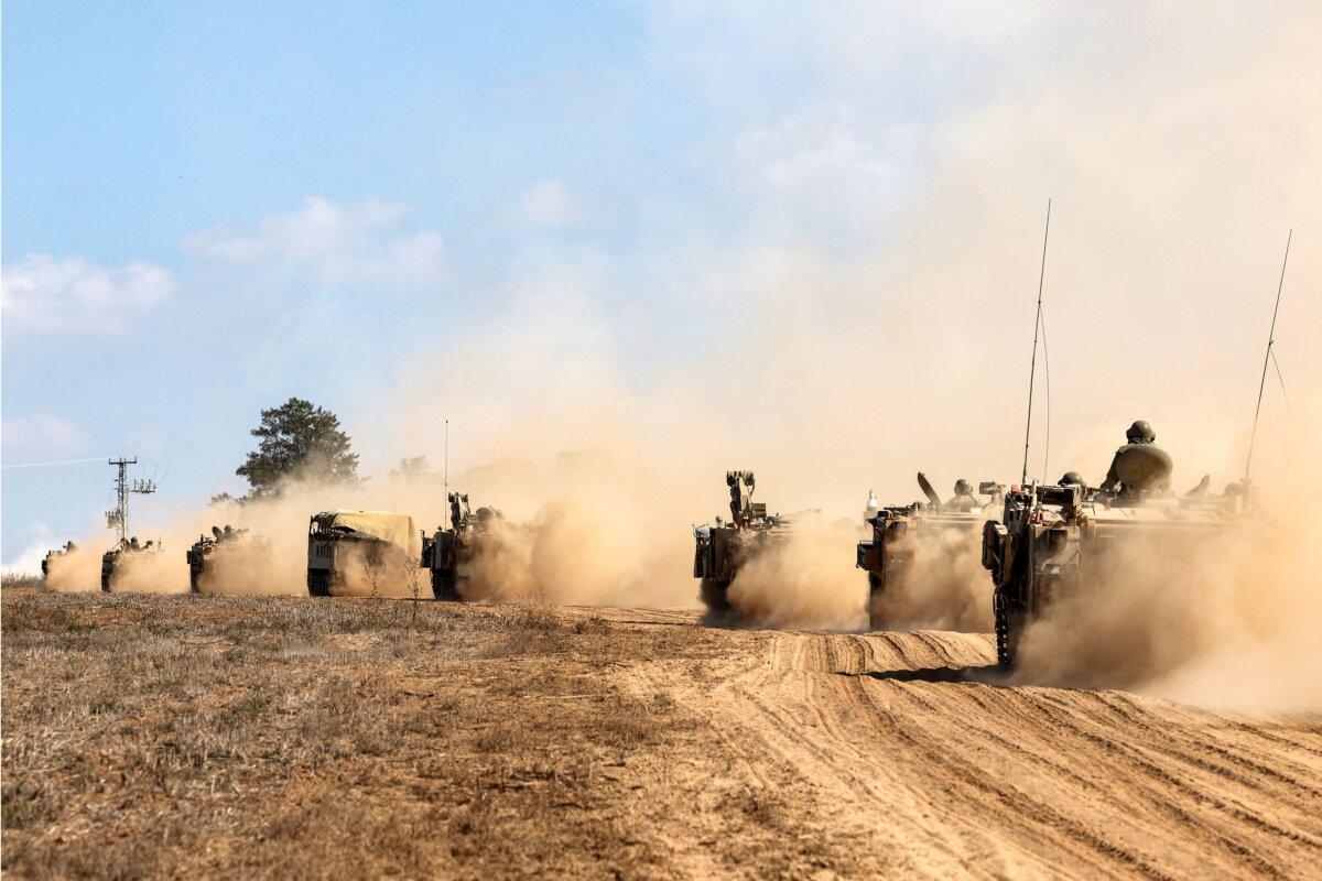 Israeli army tanks and vehicles deploy along the border with the Gaza Strip in southern Israel on Oct. 13, 2023. (Jack Guez/AFP via Getty Images)