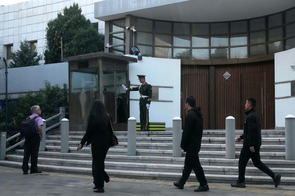 A Chinese paramilitary policeman gestures at a passerby outside the Israeli Embassy in Beijing, on Oct. 13, 2023. (Ng Han Guan/AP Photo)