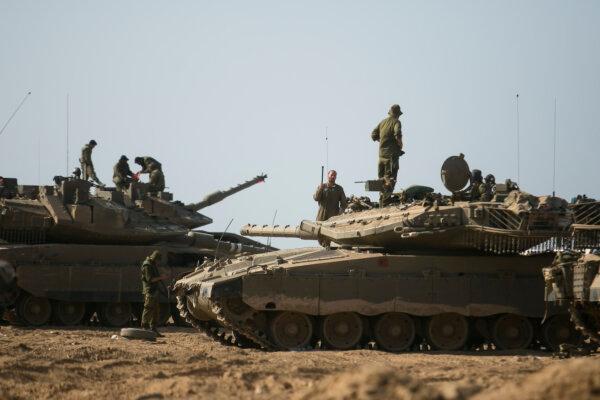 Israeli soldiers stand by tanks near the border with Gaza Near Sderot, Israel, on Oct. 14, 2023. (Amir Levy/Getty Images)