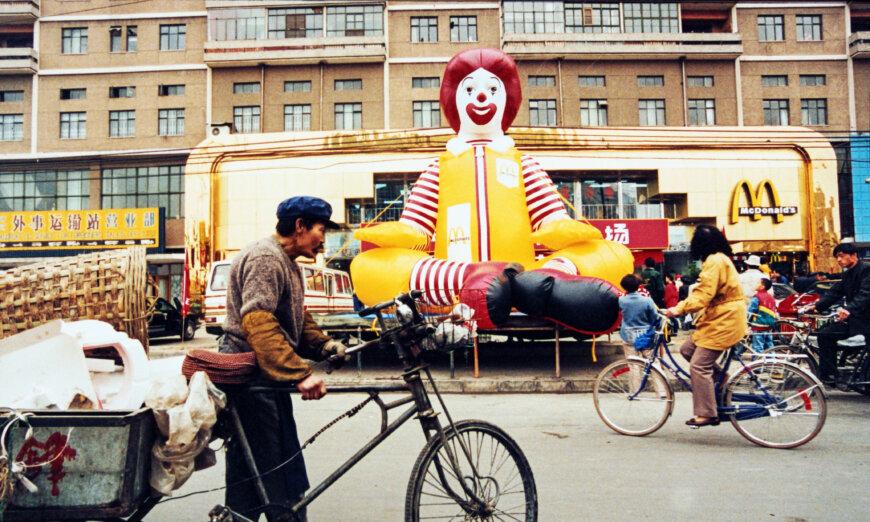 People walk by a McDonald’s restaurant in Beijing in 1994. In the early 1990s, McDonald's Corporation was among the pioneering U.S. businesses in China. (AFP via Getty Images)