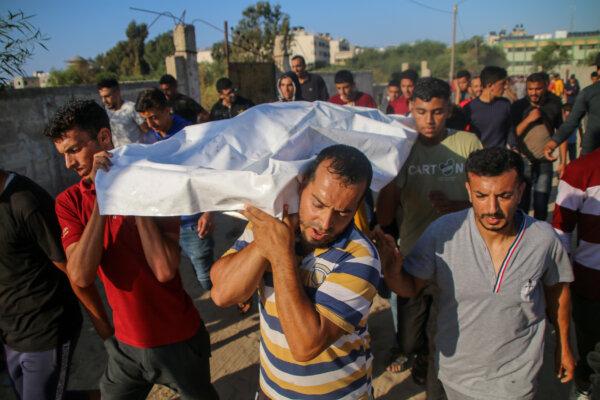 Relatives and friends mourn a Palestinian man who died in Khan Yunis, Gaza, on Oct. 19, 2023. (Ahmad Hasaballah/Getty Images)