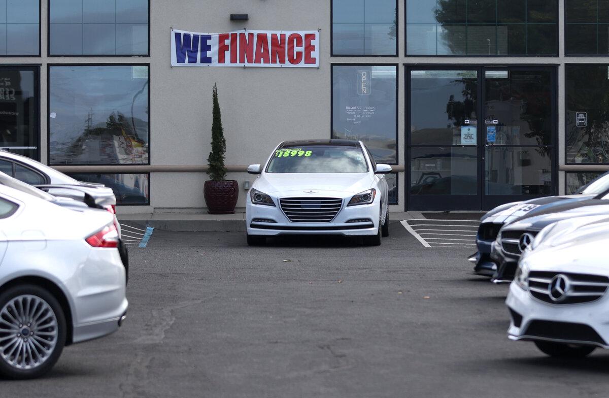 A "We Finance" sign is displayed at YG Auto Sales in Richmond, Calif., on Sept. 06, 2023. (Justin Sullivan/Getty Images)