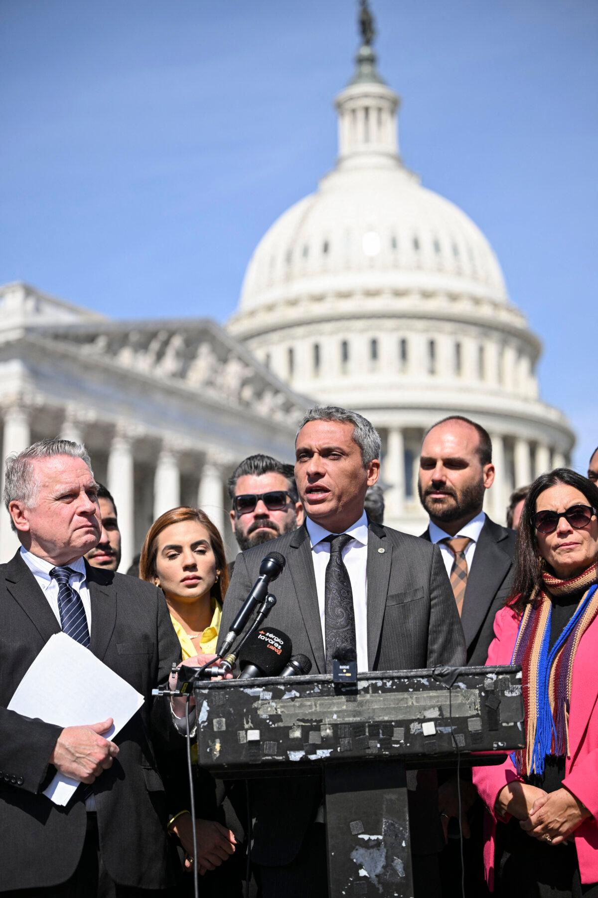Member of the Brazil Chamber of Deputies Gustavo Gayer, next to Rep. Chris Smith (R-N.J.), speaks at a news conference on "Brazil: Democracy, Freedom, and Rule of Law Under Attack?" outside of the US Capitol on March 12, 2024. (Mandel Ngan/AFP via Getty Images)