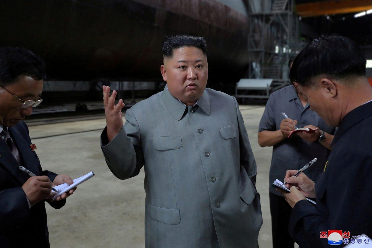 North Korean leader Kim Jong Un, center, speaks while inspecting a newly built submarine to be deployed soon, at an unknown location in North Korea. (Korean Central News Agency/Korea News Service/File Photo via AP)