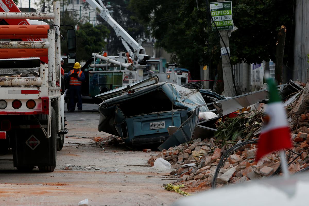 A damaged wall and a smashed vehicle are pictured after an earthquake in Mexico City, Mexico on Sept. 8, 2017. (REUTERS/Carlos Jasso)