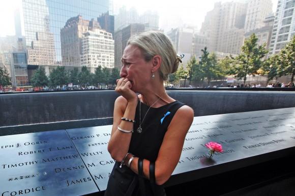 Carrie Bergonia of Pennsylvania looks over the name of her fiance, firefighter Joseph Ogren at the 9/11 Memorial during ceremonies for the 12th anniversary of the attacks at the World Trade Center site on Sept. 11, 2013 in New York City. (Chris Pedota-Pool/Getty Images)