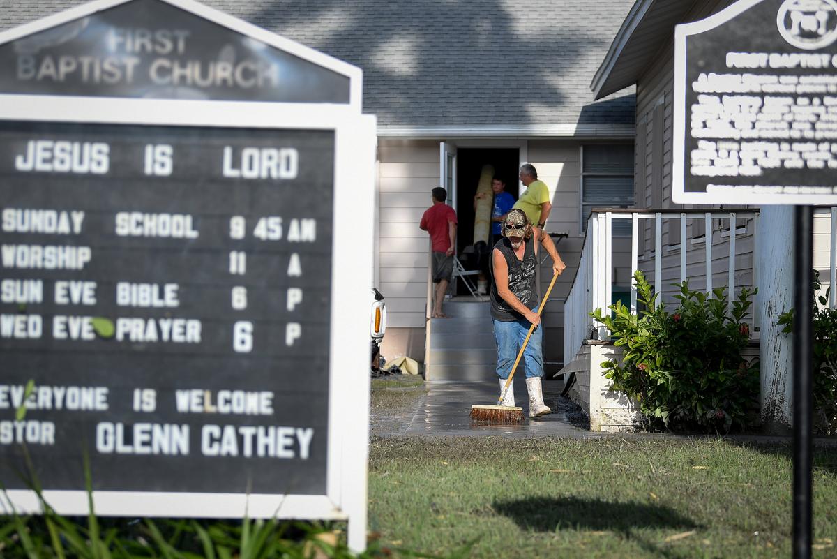 Residents clean up after Hurricane Irma heavily damaged the First Baptist Church in Everglades City, Florida on Sept. 11, 2017. (REUTERS/Bryan Woolston)