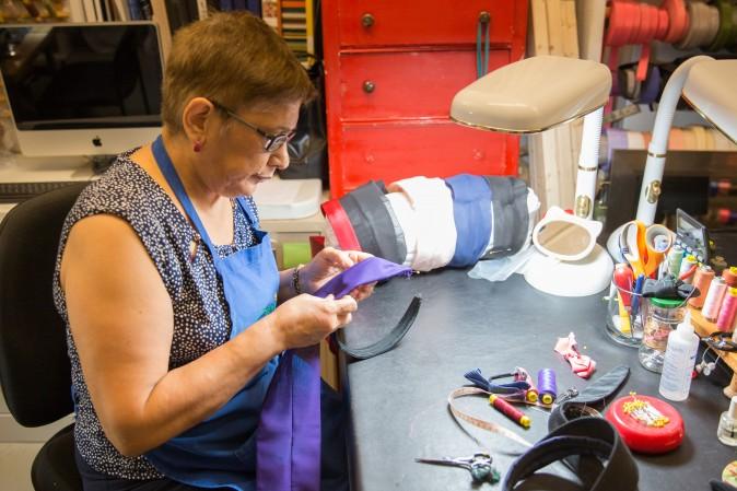 Rosa Pinto makes headbands at the Jennifer Ouellette studio. (Benjamin Chasteen/The Epoch Times)