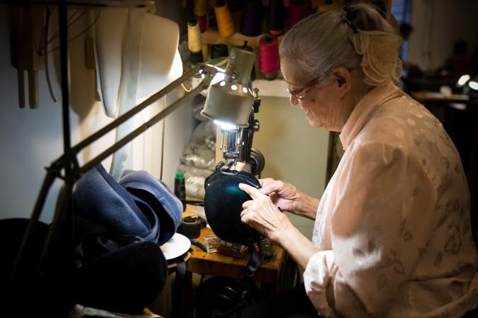 Georgina Sanchez, who has been working in the garment district for more than 40 years, uses a sewing machine that is over 100 years old at the Jennifer Ouellette studio. (Benjamin Chasteen/The Epoch Times)