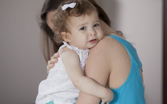 Stock photo of a mother holding her child. (Shutterstock)