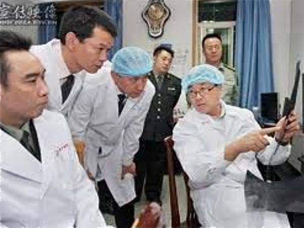 Wang Lijun is pictured showing military officials through his laboratory