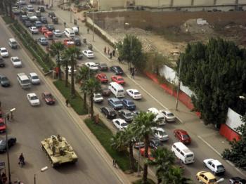 WELCOMED TANK: A military tank enters Cairo along 'pyramid row,' a thoroughfare in front of the Shaughnessy's hotel on Jan., 28, 2011. It was a day of transition, when the police force were replaced by a security force made up of the Egyptian army. Many Egyptians were happy and cheering on seeing the tanks, according to the Shaughnessys. (Courtesy of Ellen Shaughnessy) WELCOMED TANK: A military tank enters Cairo along 'pyramid row,' a thoroughfare in front of the Shaughnessy's hotel on Jan., 28, 2011. It was a day of transition, when the police force were replaced by a security force made up of the Egyptian army. Many Egyptians were happy and cheering on seeing the tanks, according to the Shaughnessys. (Courtesy of Ellen Shaughnessy)