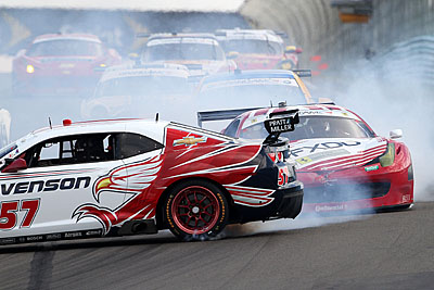 The points-leading FXDD Ferrari tangles with the Stevenson Camaro in Turn One on the first lap of the race. (Grand-am.com)