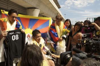 Cesar Maxit, (holding T-shirt), Kalaya'an Mendoza (seated), and Jonathan Stribling-Uss (Right) were interviewed by the press after they arrived JFK airport. The t-shirt held by Maxit is identical to the ones he, Mendoza, and Stribling-Uss displayed in t (Students for a Free Tibet )