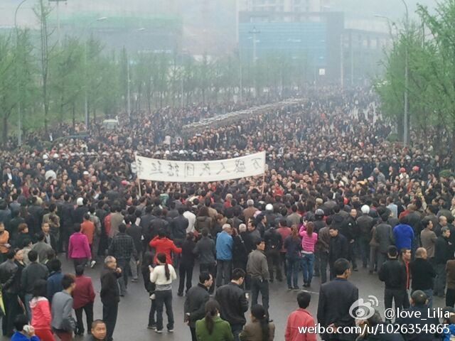 Protesters in Chongqing hold a banner saying 