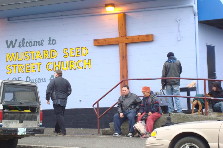 HARD TIMES: People gather outside the Mustard Seed food bank in Victoria. Close to 800,000 people used a food bank in March 2009, an increase of almost 120,000 people compared to the same time last year.  (Joan Delaney/The Epoch Times)
