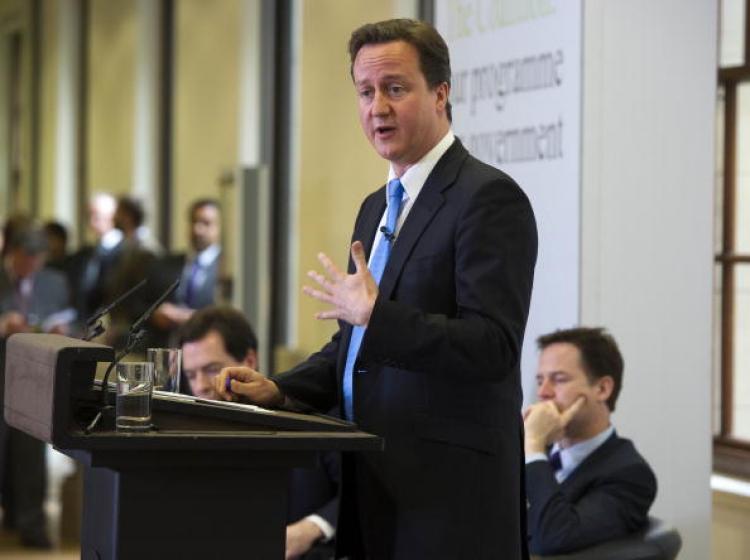 British David Cameron (standing) with Deputy Prime Minister Nick Clegg (right) at the launch of the British Government's Programme Coalition Agreement document in London, May 20, 2010.  (Roland Hoskins - WPA Pool/Getty Images)