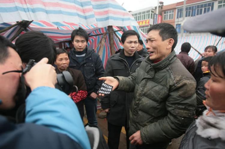 The victim's son shows three police badges. He said the police not only