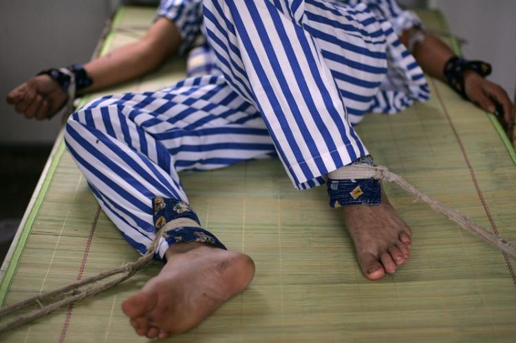 A patient strapped to a bed in a Chinese psychiatric hospital. (China Photos/Getty Images)