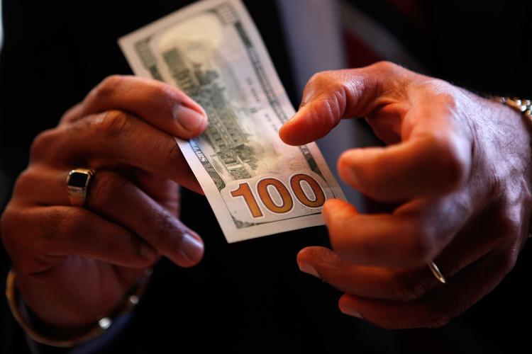 U.S. Bureau of Engraving and Printing Director Larry Felix explains some of the security features of the new $100 note after it was unveiled at the Treasury Department April 21, 2010 in Washington, DC. (Chip Somodevilla/Getty Images)