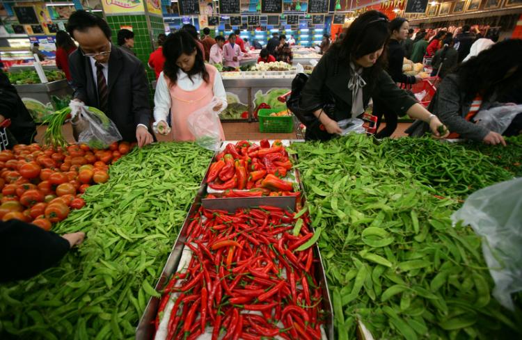 A resident of Chongqing buys vegetables at a supermarket.  (China Photos/Getty Images)