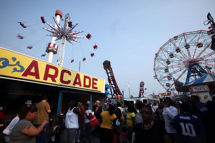 People gather on opening day of the new Luna Park amusement area (L) at Coney Island. (Mario Tama/Getty Images)