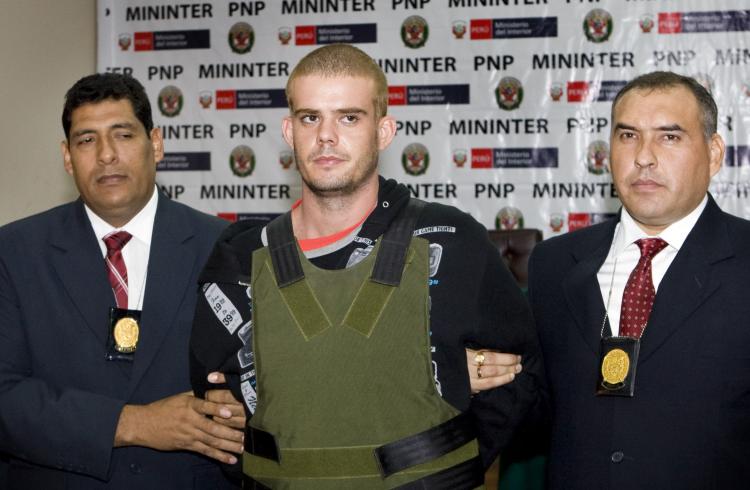 Joran van der Sloot  is escorted by Peruvian police as he arrives at the Criminal Investigation Direction office in Lima on June 5. van der Sloot  has now confessed to her murder late Monday night, according to the Peruvian government authorities.   (Marcel Antonisse/Getty Images)