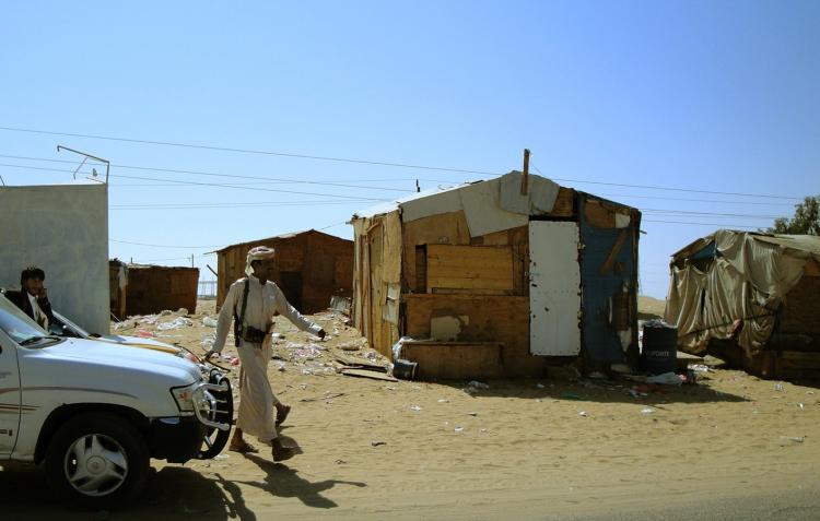 A Yemeni walks near wooden huts in the province of Marib, 118 miles east of Sana'a, June 9. The Obama administration will boost humanitarian help for Yemen by $29.6 million, providing the country with $42.5 this year, the White House announced on Thursday. (AFP/Getty Images )