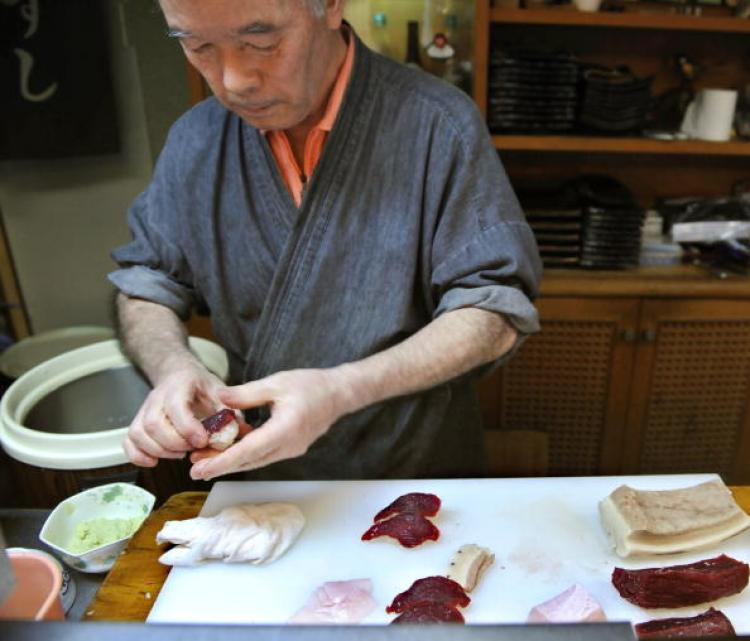 Katsuji Furuuchi makes up a whale sushi from a sliced minke meat and a rice ball in Japanese whaling town Ayukawahama, Miyagi prefecture.   (Kazuhiro Nogl/AFP/Getty Images)