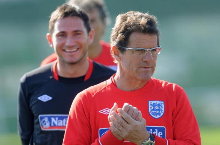 Frank Lampard smiles as England manager Fabio Capello looks on during the England training session at the Royal Bafokeng Sports Campus on June 21, 2010 in Rustenburg, South Africa. (Photo by Michael Regan/Getty Images)