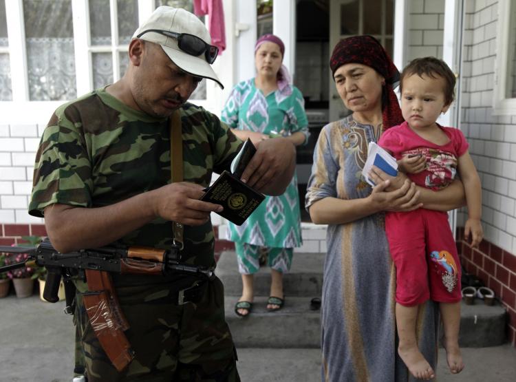 A Kyrgyz soldier checks the identification documents of ethnic Uzbeks in an Uzbek section of Osh on June 21. Kyrgyz troops abused civilians during security operations in southern Kyrgyzstan, concluded Human Rights Watch in a report published Monday. (Oxana OnipkoAFP/Getty Images )