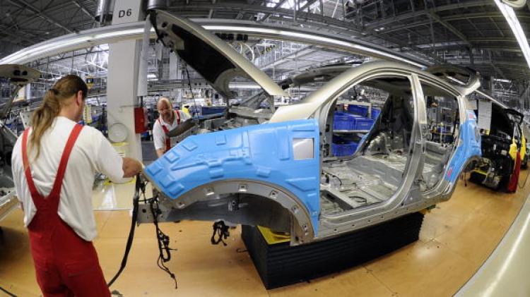 An employee works on a Kia Sportage car at the Kia Motors Slovakia factory in Teplicka nad Vahom on June 29. Car production in the EU is declining following a brief recovery period after 2009 lows.   (Eduard Genserek/Getty Images)