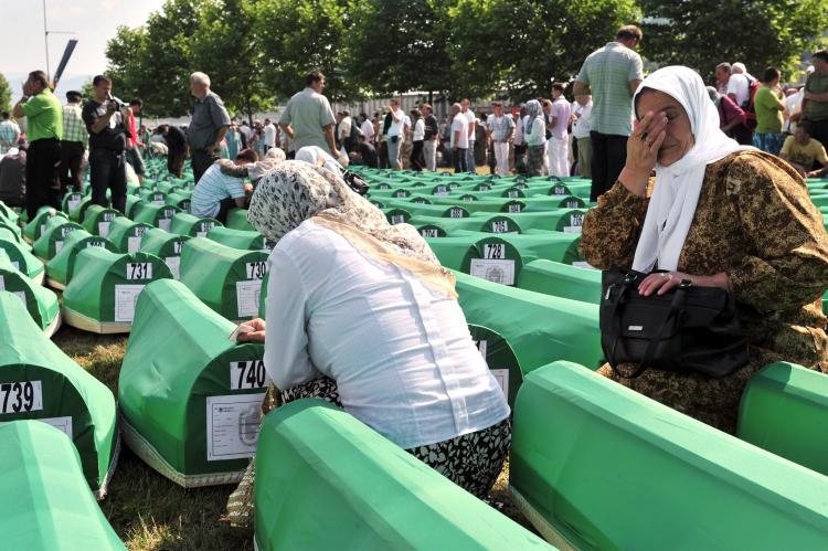 Bosnian Muslim women cry on July 11, for the victims of the 1995 Srebrenica massacre, during a ceremony at the Srebrenica Memorial Cemetery in Potocari. It is to commemorate the nearly 8,000 Muslims killed by Bosnian Serbs and bury 775 newly identified victims.(Elvis Barukcic/Getty Images)