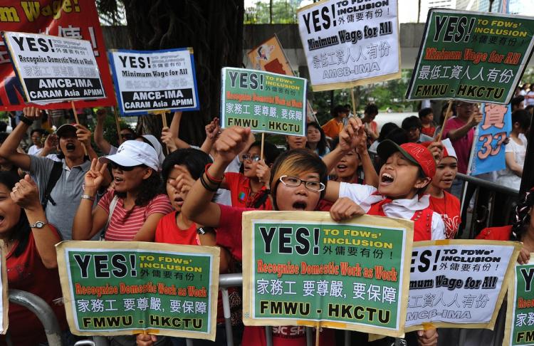 A group of domestic helpers protest for a minimum wage outside the Legislative Council in Hong Kong on July 14. (Mike Clarke/Getty Images)