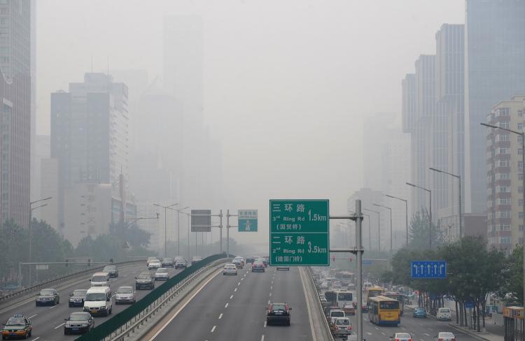 As vehicles travel through central Beijing, smog is seen hovering over the city. According to the Ministry of Environmental Protection's director, more than 30 percent of China's urban population lives in areas with poor air quality, and that pollution is especially bad between Beijing and Shanghai. (Frederic J. Brown/Getty Images)