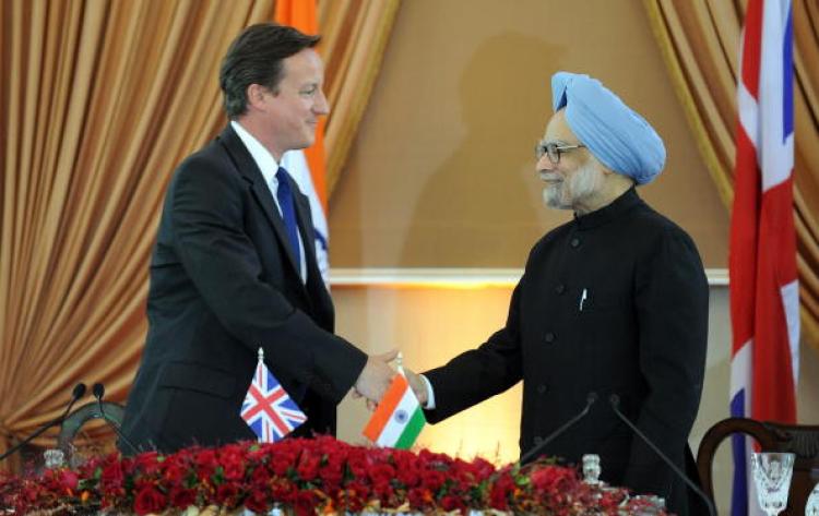 British Prime Minister David Cameron (L) shakes hands with Indian Prime MInister Manmohan Singh after an agreement signing in New Delhi on July 29, 2010. Cameron will push Indian leaders to strengthen trade ties on the second leg of his visit.(Prakash SINGH/AFP/Getty Images) )