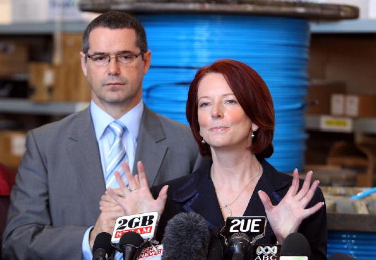 Prime Minister Julia Gillard discusses the National Broadband Network with Stephen Conroy, Minister for Broadband and Communications, from the warehouse of Network Service Provider, VisionStream on July 30 in Perth, Australia.  (Paul Kane/Getty Images)