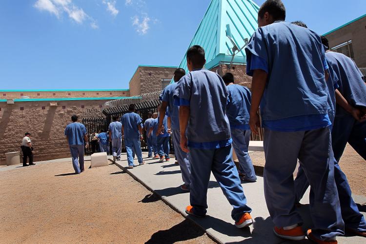 Detained immigrants walk back to their housing units following lunch at the U.S. Immigration and Customs Enforcement (ICE) detention facility on July 30, in Florence, Arizona.  ( John Moore/Getty Images)