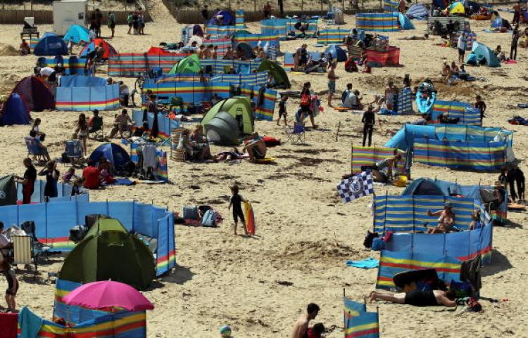 Holidaymakers gather at Harlyn Bay near Padstow on July 28, 2010, in Cornwall, England. With good weather forecast many Britons will be making the most of the Bank Holiday weekend.   (Getty Images )