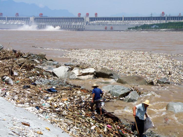 Workers clean up along the banks of the Yangtze River near the Three Gorges Dam in Yichang, in central China's Hubei province on August 1, 2010. (AFP/Getty Images)