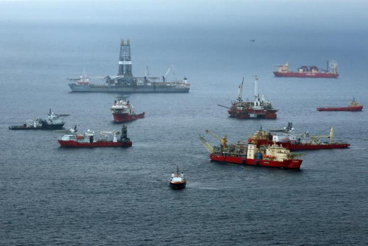 Vessels work at the site of the Deepwater Horizon accident August 10, off the shore of Louisiana. BP, which nearly one month ago plugged the blowout on its oil well, has announced that it will delay plans to drill offshore in Libya.   (Win McNamee/Getty Images)